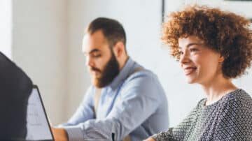 Business woman talking to two colleagues